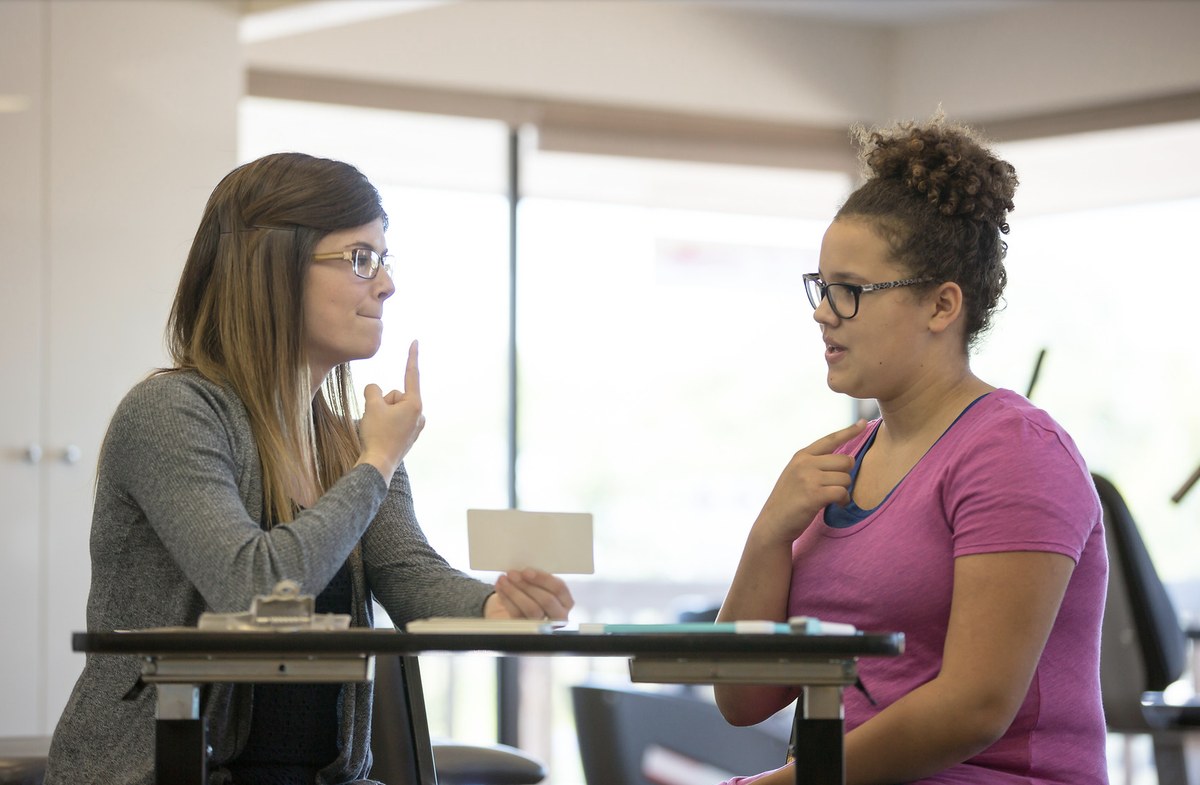 Speech therapist in a telehealth-style consultation