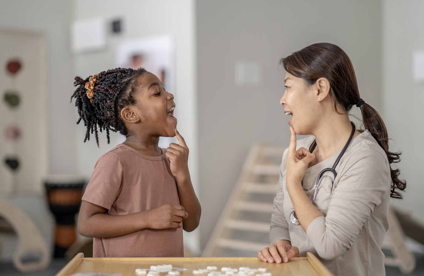 Speech pathologist helping a child practise speech sounds